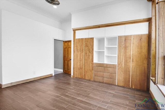 501 S Harrison St, Longview, TX 75601 - unfurnished bedroom with crown molding, wood finished floors, and baseboards