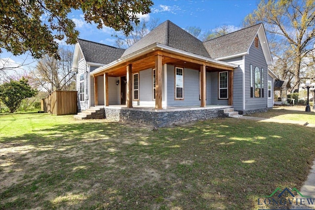 501 S Harrison St, Longview, TX 75601 - view of front facade with a shingled roof, a porch, and a front yard