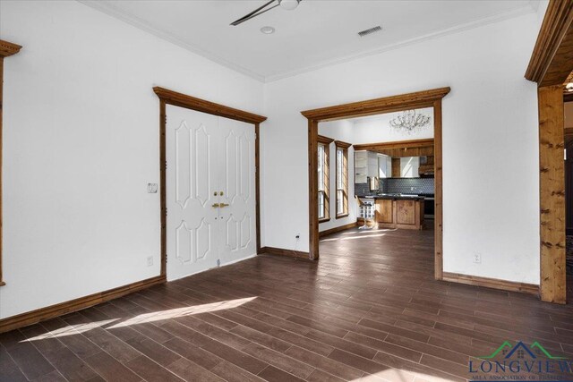 501 S Harrison St, Longview, TX 75601 - unfurnished living room featuring crown molding, dark wood finished floors, and baseboards