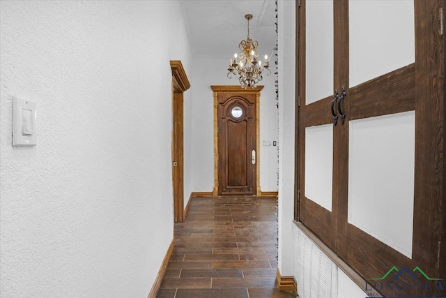 501 S Harrison St, Longview, TX 75601 - hall with a chandelier, dark wood finished floors, baseboards, and crown molding