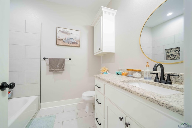 bathroom featuring tile patterned floors, toilet, vanity, tub / shower combination, and baseboards