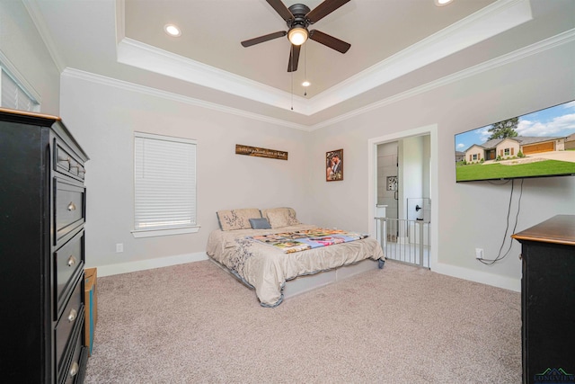 bedroom featuring carpet, recessed lighting, ornamental molding, and a raised ceiling