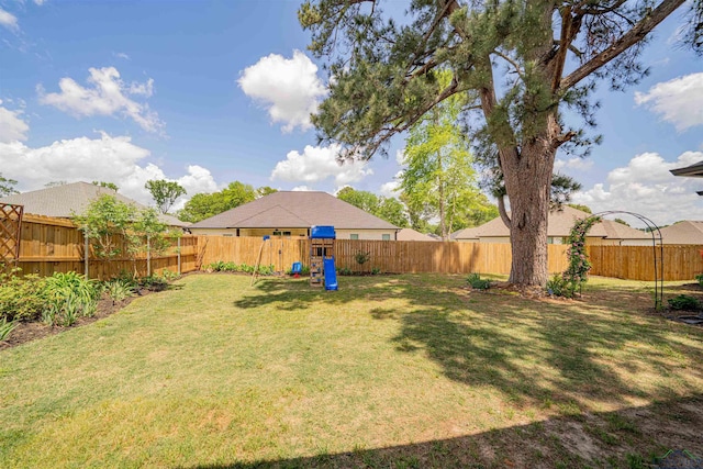 view of yard featuring a fenced backyard and a playground