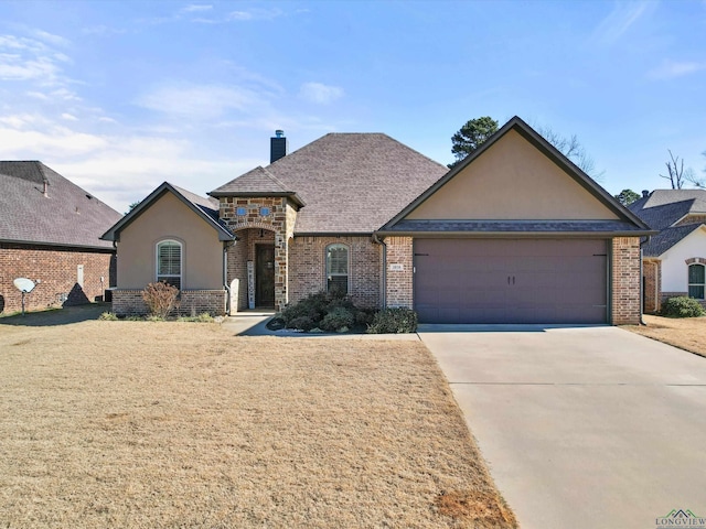 view of front facade with a garage and a front lawn