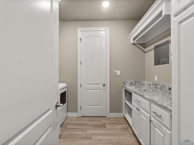 washroom featuring washer / clothes dryer and light hardwood / wood-style flooring