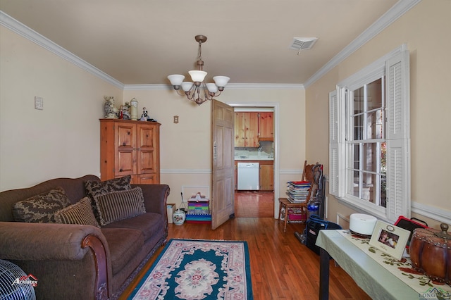 living room with a healthy amount of sunlight, dark hardwood / wood-style flooring, crown molding, and a chandelier