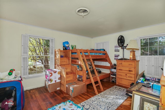 bedroom featuring dark wood-type flooring and ornamental molding