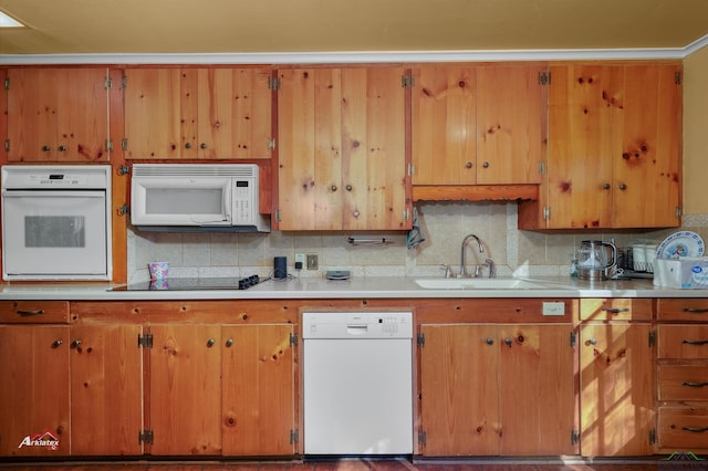 kitchen with sink, white appliances, and backsplash