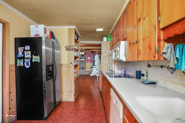 kitchen featuring tasteful backsplash, ornamental molding, white appliances, ceiling fan, and sink