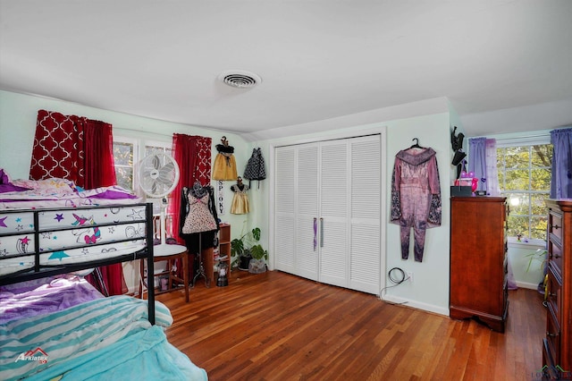 bedroom with a closet and dark hardwood / wood-style floors