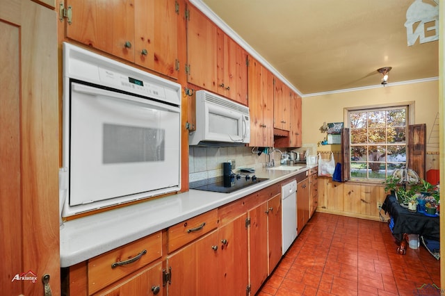 kitchen featuring decorative backsplash, white appliances, ornamental molding, and sink