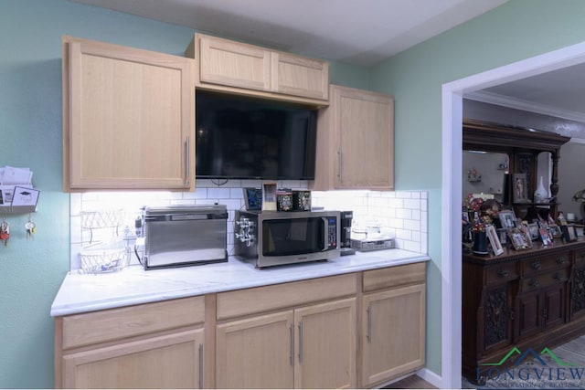 kitchen featuring decorative backsplash, light brown cabinetry, and ornamental molding