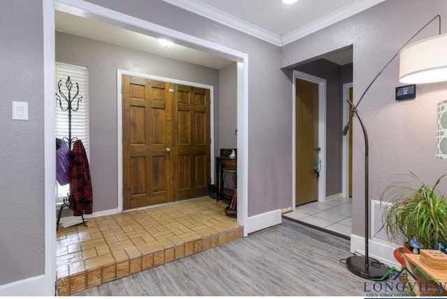 foyer entrance featuring ornamental molding