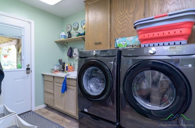 washroom with cabinets, separate washer and dryer, and light hardwood / wood-style flooring