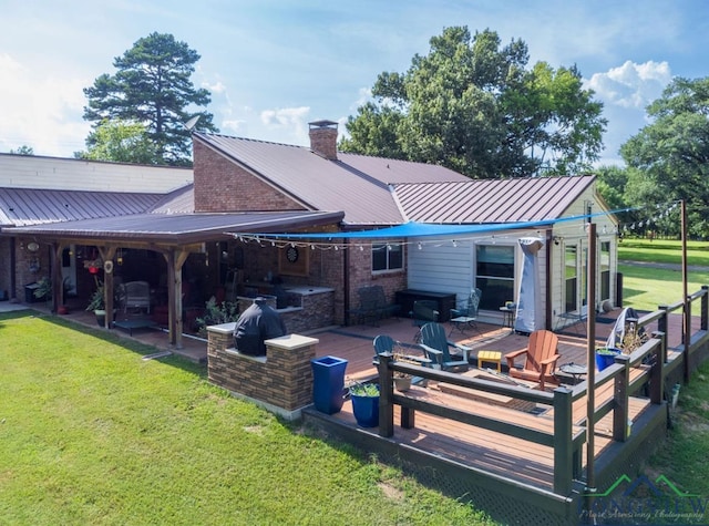 back of property featuring a wooden deck and a yard