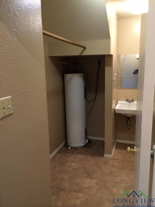 bathroom with water heater and sink