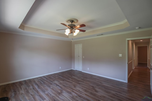 1302 Jeff Davis Dr, Tyler, TX 75703 - unfurnished room featuring a tray ceiling, ceiling fan, dark wood-style floors, a smoke detector, and crown molding
