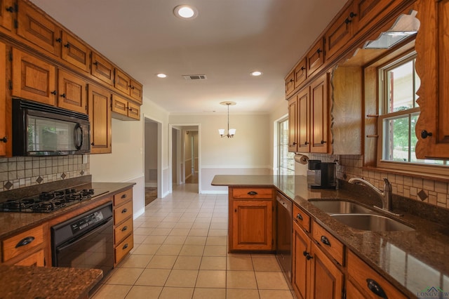 1302 Jeff Davis Dr, Tyler, TX 75703 - kitchen featuring black appliances, brown cabinets, light tile patterned flooring, tasteful backsplash, and pendant lighting