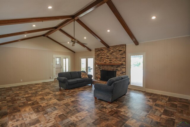 1302 Jeff Davis Dr, Tyler, TX 75703 - living room featuring a ceiling fan, plenty of natural light, a brick fireplace, recessed lighting, and wooden walls