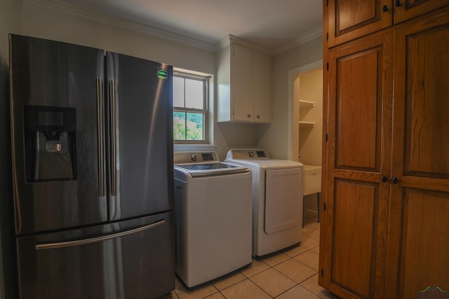 1302 Jeff Davis Dr, Tyler, TX 75703 - laundry room featuring washing machine and dryer, light tile patterned floors, crown molding, and cabinet space