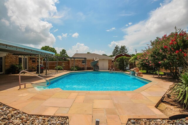 1302 Jeff Davis Dr, Tyler, TX 75703 - view of swimming pool with a water slide and a patio