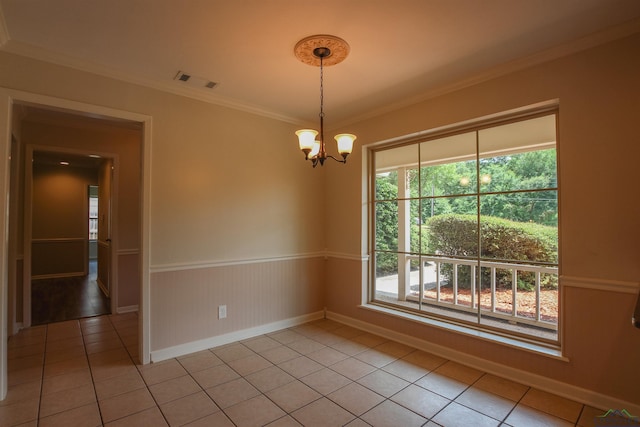 1302 Jeff Davis Dr, Tyler, TX 75703 - empty room featuring light tile patterned flooring, a chandelier, ornamental molding, healthy amount of natural light, and wainscoting