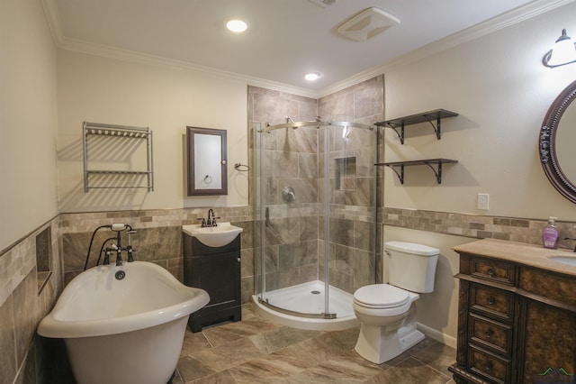 1302 Jeff Davis Dr, Tyler, TX 75703 - bathroom featuring tile walls, vanity, a shower stall, a freestanding bath, and wainscoting