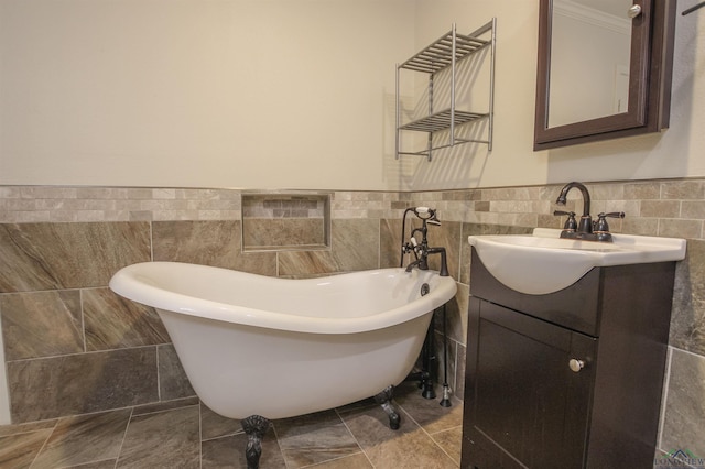 1302 Jeff Davis Dr, Tyler, TX 75703 - bathroom with tile walls, vanity, a freestanding tub, a wainscoted wall, and ornamental molding