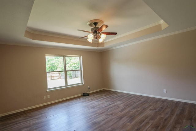 1302 Jeff Davis Dr, Tyler, TX 75703 - spare room with a raised ceiling, a ceiling fan, dark wood finished floors, and ornamental molding