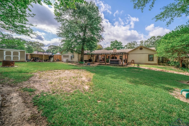 1901 Azalea St, Gilmer, TX 75644 - rear view of house with a fenced backyard, a chimney, an outdoor structure, a yard, and a shed