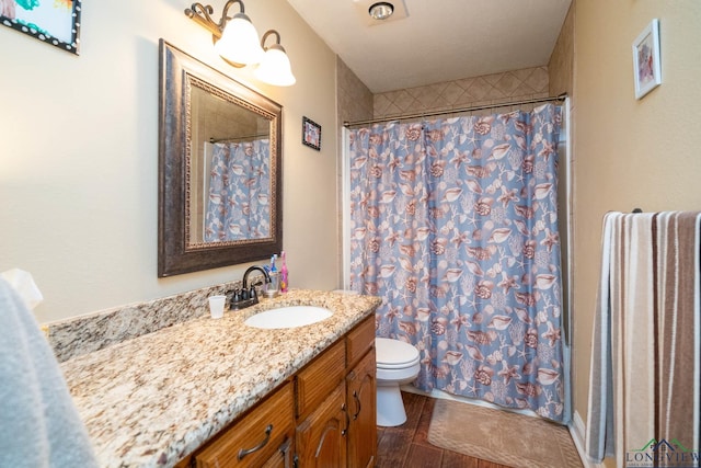 1901 Azalea St, Gilmer, TX 75644 - bathroom with vanity, a shower with shower curtain, and toilet