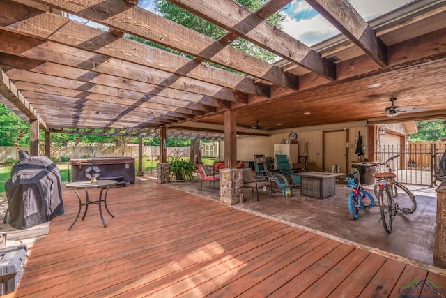 1901 Azalea St, Gilmer, TX 75644 - wooden deck featuring outdoor dining space, a hot tub, a fenced backyard, and ceiling fan
