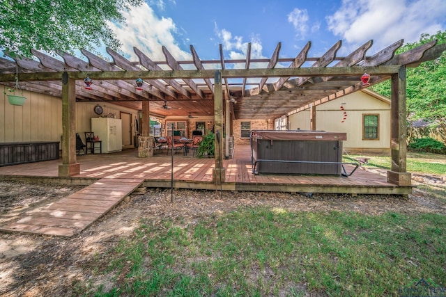 1901 Azalea St, Gilmer, TX 75644 - back of property with ceiling fan, a wooden deck, a hot tub, and a pergola