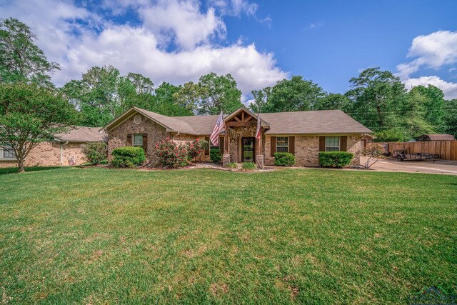 1901 Azalea St, Gilmer, TX 75644 - ranch-style home featuring fence, a front lawn, and roof with shingles