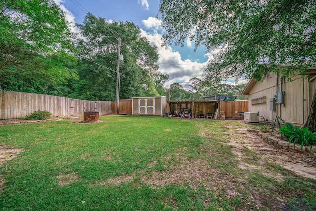 1901 Azalea St, Gilmer, TX 75644 - view of yard with a fenced backyard, an outbuilding, central AC, and a shed