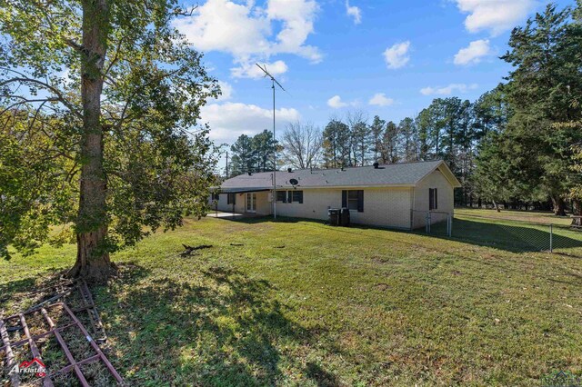 rear view of house with a yard