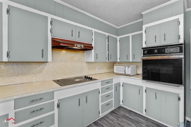 kitchen with a textured ceiling, gray cabinets, ornamental molding, and black appliances