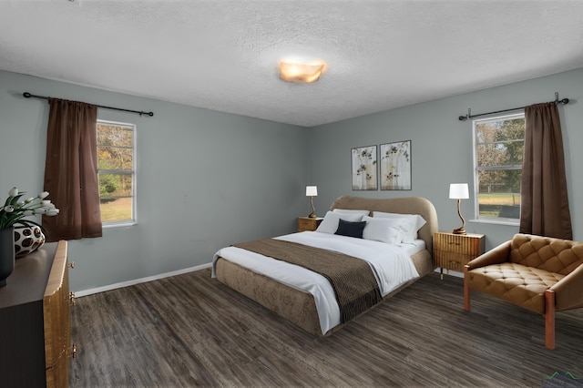 bedroom featuring a textured ceiling and dark wood-type flooring