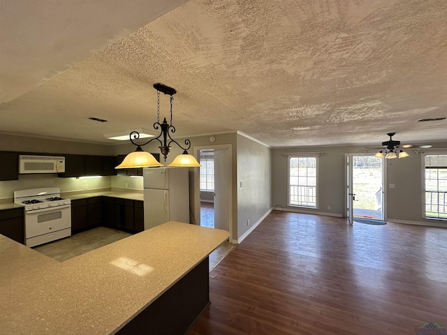587 Floyd Evans Rd, Marshall, TX 75672 - kitchen featuring visible vents, white appliances, wood finished floors, and light countertops