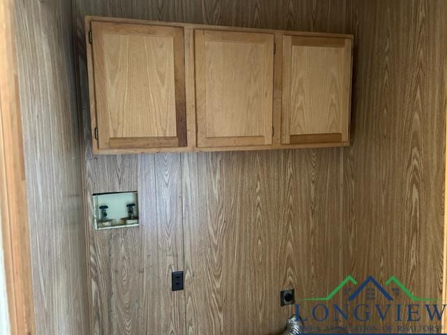 washroom featuring electric dryer hookup, hookup for a washing machine, and cabinets