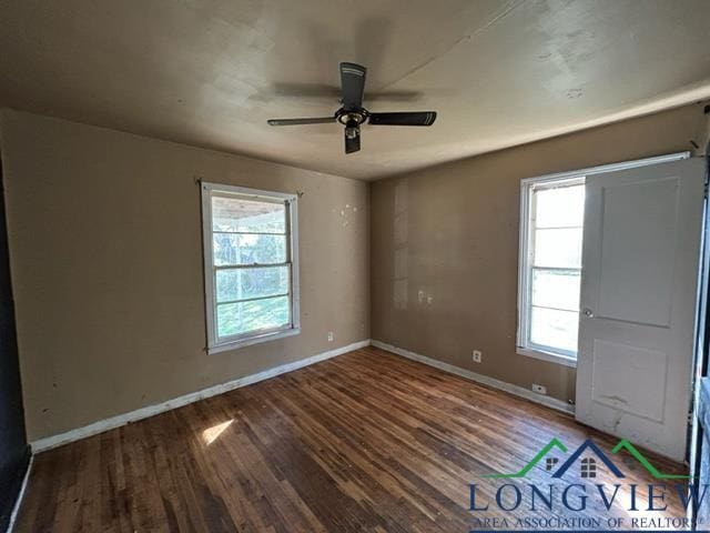 spare room with hardwood / wood-style flooring, ceiling fan, and a healthy amount of sunlight