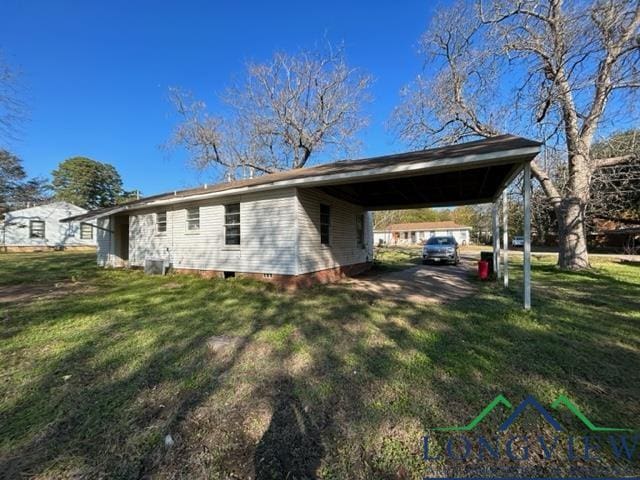 view of property exterior with a yard and a carport