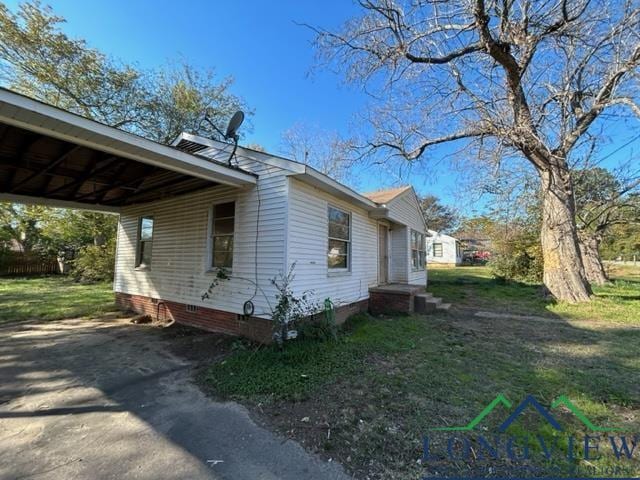 view of property exterior featuring a carport