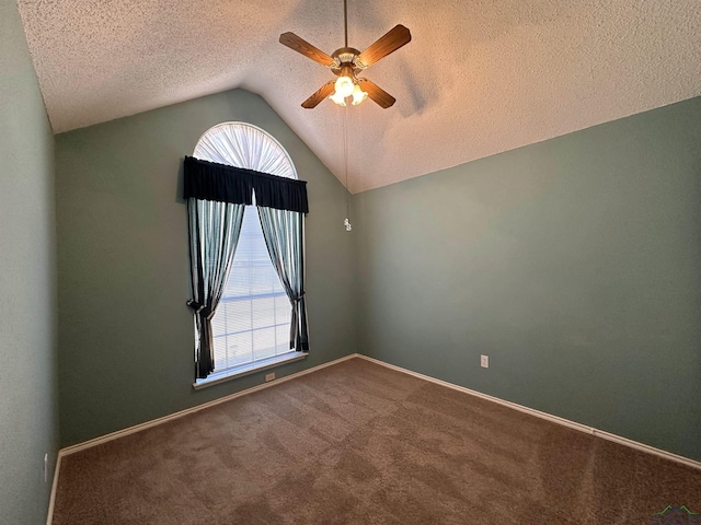 carpeted spare room featuring lofted ceiling, a textured ceiling, and ceiling fan