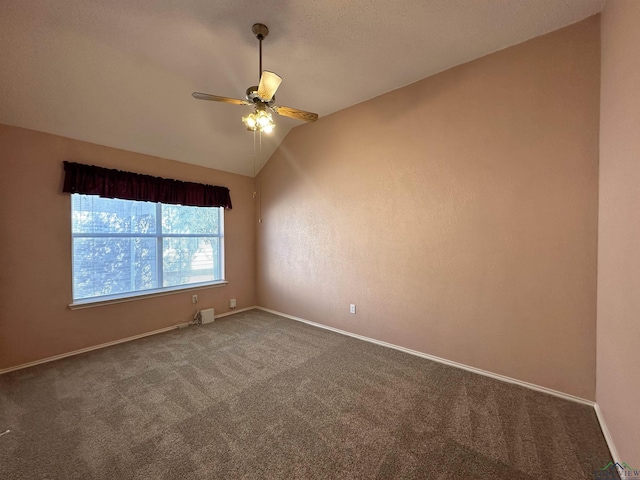 carpeted spare room with vaulted ceiling and ceiling fan