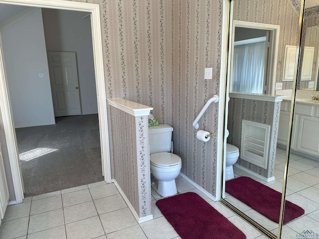 bathroom featuring vanity, tile patterned floors, and toilet