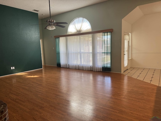 empty room featuring hardwood / wood-style flooring, a textured ceiling, and ceiling fan