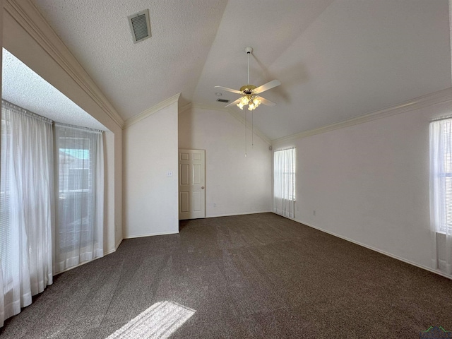 unfurnished room with dark colored carpet, crown molding, lofted ceiling, and a textured ceiling