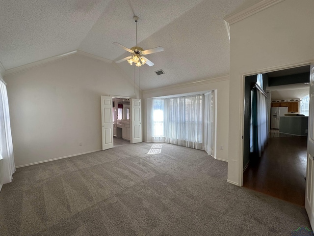 unfurnished living room with ceiling fan, carpet floors, ornamental molding, and a textured ceiling