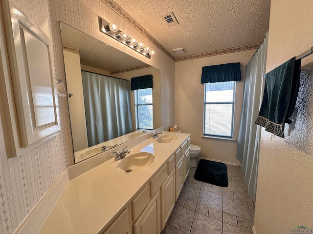 bathroom with vanity, tile patterned floors, a textured ceiling, and toilet